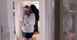 © Marco - Mother holding baby in hallway with reflection on tiles, candid authentic lifestyle scene, intimate family moment, nurturing and bonding, warm and natural light