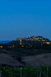 Pienza shining on the Tuscan hills at blue hour in Val d'Orcia, Italy