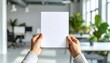 © Agus - Capture attention with this blank flyer held in a bright, modern office setting now