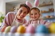 © AltisArt - : Happy Mother and Daughter Wearing Bunny Ears, Painting Easter Eggs Together