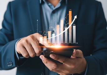 Businessman using smartphone with glowing financial chart showing upward trend and growth arrow, business concept