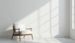 © FimCraft - A comfortable white armchair sits bathed in sunlight next to a window against a plain white wall, creating a minimalist and serene interior space for relaxation.