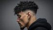 © buraratn - Curly hairstyle with fade side profile of man dark curly hair stylish haircut urban fashion earring serious expression modern look close up textured hair