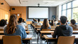 © Mohammad - Students attentively seated in a lecture hall, engaged in a learning environment with a projection screen
