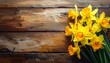 © Davin - Vibrant yellow daffodils artfully arranged on a rustic, textured wooden surface, creating a warm and inviting spring scene.