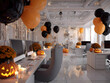 © Вікторія Білик - Modern office workspace decorated for Halloween. Gray chairs, monitors on white tables. Holiday decorations: pumpkins with candles, black and orange balloons, spider webs. Bright lights, spooky, cozy