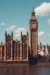 © tanaonte - Majestic big ben clock tower against blue sky and white clouds, a symbol of london and england