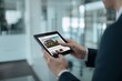 © Volodymyr Hankevych - Businessman using a tablet to browse a real estate website.