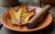 © zhao - Weathered tobacco leaf and rustic cigar on terracotta plate. High quality