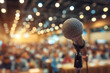 © Ima - Microphone poised onstage awaits speaker at crowded conference