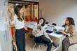 © Yaroslav Astakhov - A group of team members is actively brainstorming innovative ideas while situated in a modern office environment