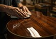 © Ahmdfadhilah - Experienced craftsman hands carefully polishing a beautiful handmade wooden acoustic guitar with a soft cloth, enhancing its glossy finish