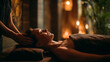 © Abeetha Prasad - Woman receiving a head massage at a spa in a dimly lit relaxing environment