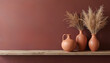 © Vadym - Rustic wooden shelf displays terracotta vases with dried flowers against burgundy wall. Home decor art minimalist design. Neutral warm colors interior background.