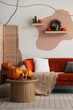 © Pixel-Shot - Interior of cozy living room with sofa, table and autumn decor