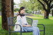 © NANKHAMMAI - A female student with a backpack reads a book in a university quietly, attentive to her studies and enjoying learning with the inspiration to succeed.