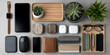 © chok - Smartphone watch glasses wallet succulent pen tech accessories modern desk setup with organized items and greenery