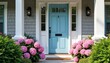 © Viktor - Charming blue front door framed by vibrant pink hydrangeas and lush plants. This inviting entrance enhances home curb appeal with its beautiful summer bloom and traditional architecture.