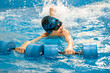 © Maria - Boy swimming with water dumbbells in hands in swimming pool