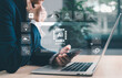 © JD8 - Businessman using laptop and smartphone with AI agents holographic interface. Artificial intelligence for automation, chatbots, data analytics and digital transformation in smart business.