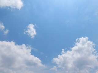 Wall Mural - Blue sky with puffy white cumulus clouds. White cumulus clouds floating in a clear blue sky. Soft white clouds float in the clear blue sky. Natural sky background.
