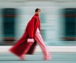© Miss V - Fashionable woman in bold red coat and pink trousers walking with style, holding a chic handbag. Stylish street fashion editorial with motion blur, urban elegance, and modern sophistication.