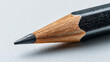 © zuriya - A sharp graphite pencil tip made of wood, poised to write or draw on a white surface.