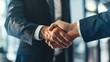 © Qggo - Professional Unity: Polished Workplace Business Handshake – Two Colleagues, Partners, or Clients Greeting with a Firm, Confident Handshake in a Modern Office Setting, Suits or Business Casual Attire