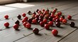© Danang - Scattered Cherries on Wooden Surface.