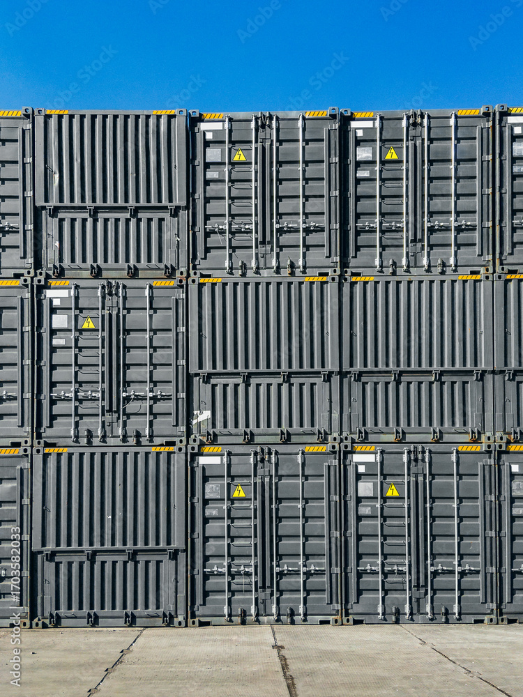 Container transportation. Stacks of gray shipping containers. A large ...