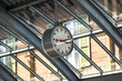 © S J Lievano - Swiss railway station clock with its distinctive minimalist design and red second hand, hanging under a glass roof structure. A symbol of precision and punctuality in Swiss train stations