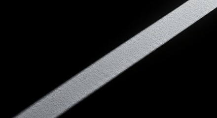 Canvas Print - Diagonal White Light Beam Illuminating a Textured Dark Surface image photo