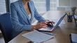 © stockbusters - Accountant fingers texting laptop writing business report at workplace closeup