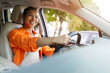 © Anastasiya - Happy African American woman driving car with wide smile, showing joy and confidence. Concept of lifestyle, independence, and everyday positive commuting