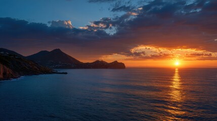 Wall Mural - The sun sets on the horizon, casting golden light over the calm sea. Mountains rise in the background, silhouetted against a colorful twilight sky with scattered clouds.
