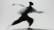 © Belvedere studio - A blurred silhouette of a dancer in motion, showcasing dynamic movement and grace. The background is plain white, emphasizing the dancer's form.