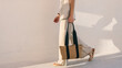 © shine.graphics - Woman carrying tote bag walking in the sunshine