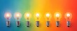 © KanitChurem - Row of glowing light bulbs on a colorful gradient background