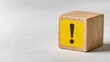 © Sutasinee - a wooden cube with a warning sign icon, An Exclamation Mark icon, Notice icon symbol, Alert safety danger caution, Notification error, and a maintenance concept. safety concept