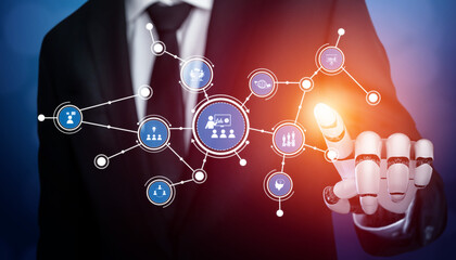 A businessman uses a robotic hand to engage with a digital social network interface, showcasing the intersection of technology and modern business practices in a vibrant setting. Tessel