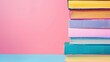 © Wa Bale - A vibrant stack of colorful books on a pastel background, perfect for educational or creative themes
