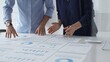 © rogerphoto - Professional team analyzing financial reports, sharing insights and planning strategic decisions in modern workplace setting. Business people concept