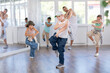© JackF - Expressive sports boy learning modern street dancing during group class in modern choreographic studio