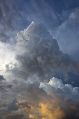 Wall Mural - Dramatic storm clouds before a thunder-storm at sunset.