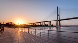Vasco da Gama bridge during sunset and ebb-tide in Lisbon, Portugal. Timelapse