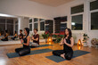 © phoenix021 - Three people man and woman meditating together on yoga class indoors, two middle aged women and younger man , guided mediation