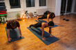 © phoenix021 - Three people man and woman doing arms and shoulder stretches on yoga class