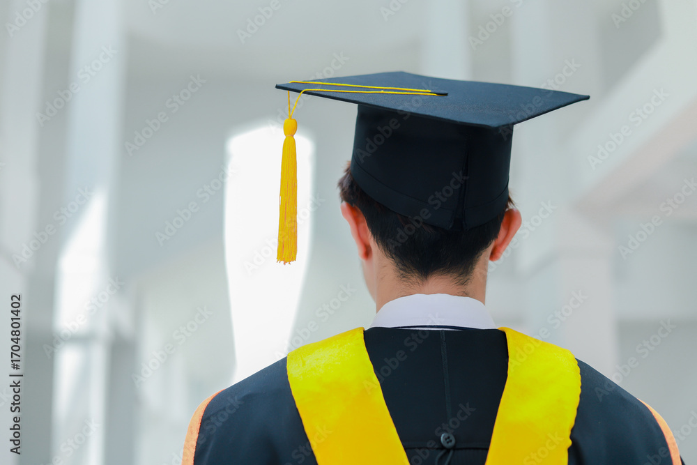 Back view of graduates celebrating their college graduation with pride ...