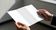 © Sumiati - Unveiling Blank Tri-fold Brochure in Executive's Hands Indoors
