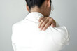 © Orathai - Woman having shoulder pain pain during work long time. stretching to relax and relax while working hard at the office